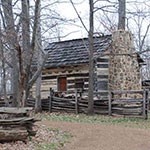 log cabin with log fence