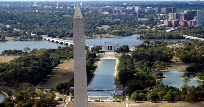 The lincoln memorial with reflecting pool and washington monument in front, bridge and river behind.