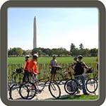 Bicycle tourists with washington monument behind them