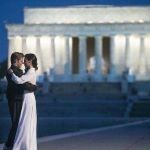 Two people dance along the Reflecting Pool with the Lincoln Memorial in the background