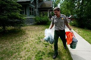 DENA Waste a park employee carries portable toilet cans in Denali National Park