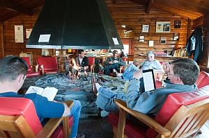 a group warms up around an indoor fire in Katmai National Park