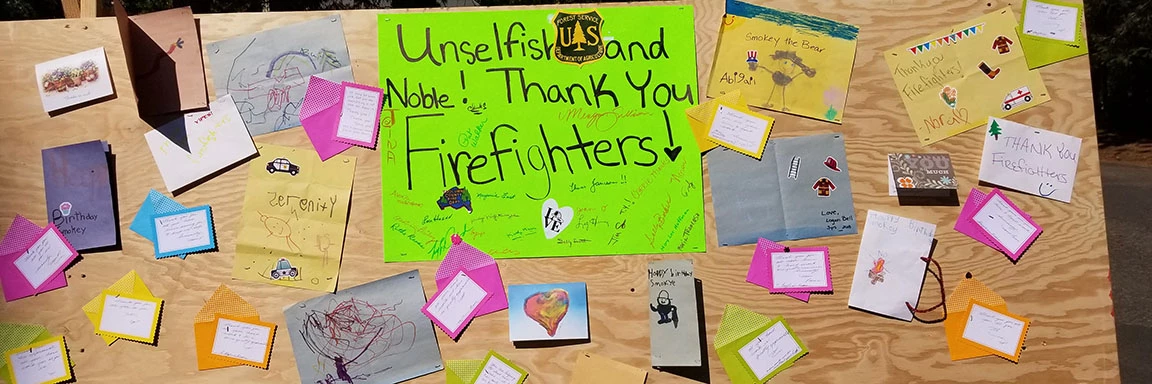20180813_101000 A fire camp board filled with posters and thank you cards.