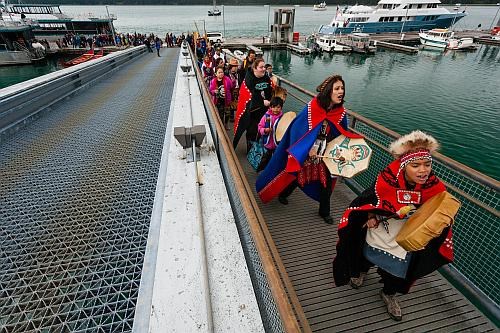 Tribal members walk up a dock in Glacier Bay National Park