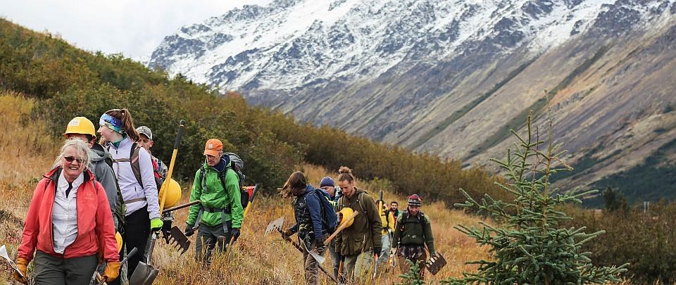 a volunteer trail crew carries tools while walking