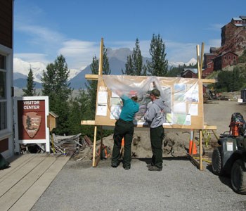 Information Officers posting Chakina Fire maps on an information board in Kennecott, Wrangell-St. Elias NP, 2009