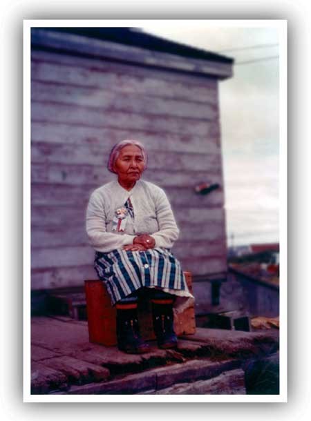 Palakia Melgenak, Photograph from "Mount Katmai, Alaska Eruption Tape Recording
Wilbur A. Davis of the University of Oregon, July-August 1961." NPS-AKSO Katmai park file. A woman sitting down with her hands folded in her lap.