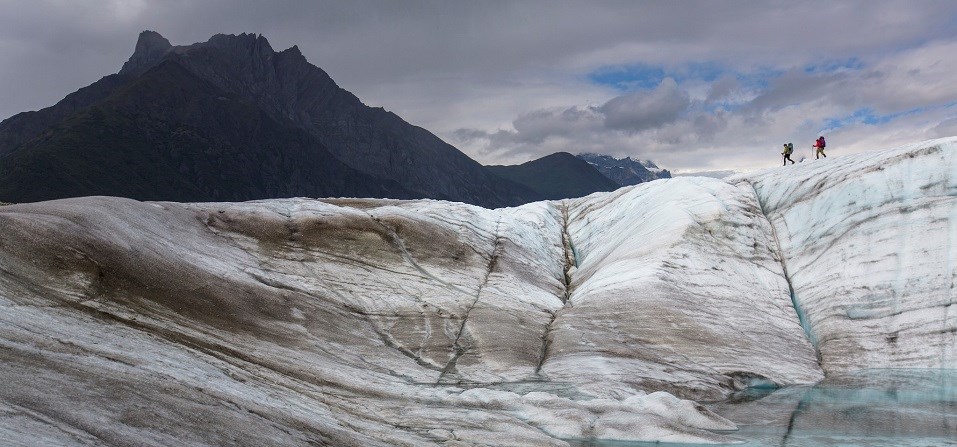 Backpackers Exploring the Root Glacier Backpackers Exploring the Root Glacier, Wrangell-ST. Elias. Two backpackers on glacier.
