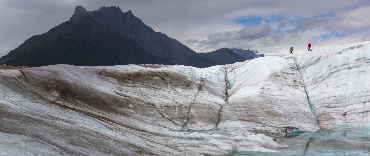 Backpackers exploring the Root Glacier, Wrangell-St. Elias Backpackers Exploring the Root Glacier, Wrangell-St. Elias