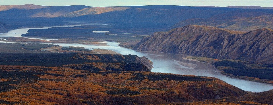 Yukon-Charley Rivers a rive winds through mountains covered in orange vegetation