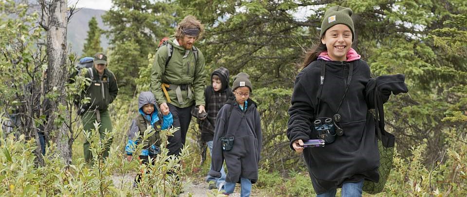 children walk along a trail with park rangers during Denali Kids Camp