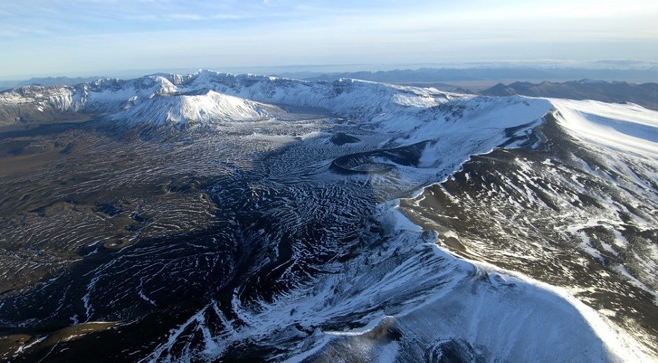 an aerial image of snowy Aniakchak Caldera