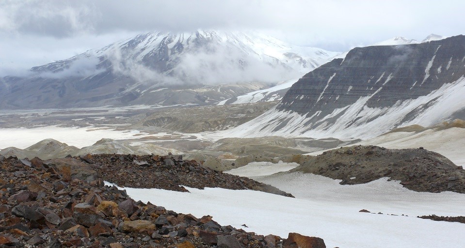 Katmai Knife Creek Glacier Red rocks and a glacier are backdropped by snowy mountains