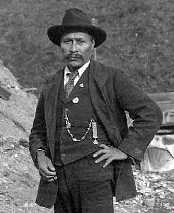 An image of a native man dressed in a suit and hat.