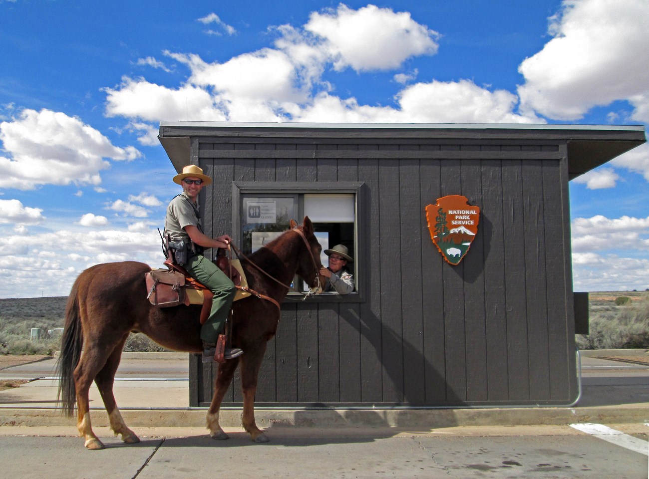 Ranger on horse stopped in front of park fee booth