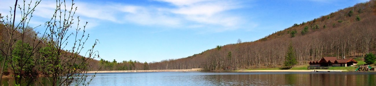 Forested hills surround a body of water.