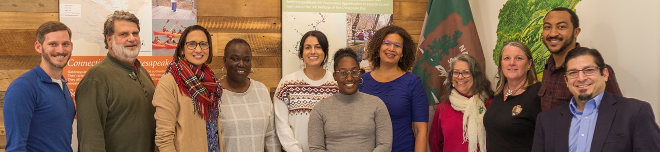 A group photo of several adults in business casual attire.