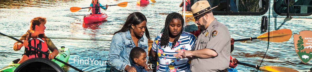58 Education Header A park ranger speaks with a family.