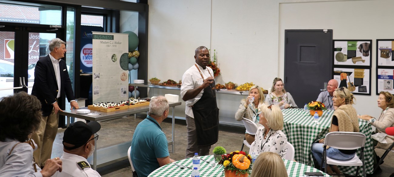 lt= A man doing a cooking demonstration