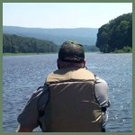 Ranger canoeing with mountains inthe distance Ranger canoeing with mountains inthe distance