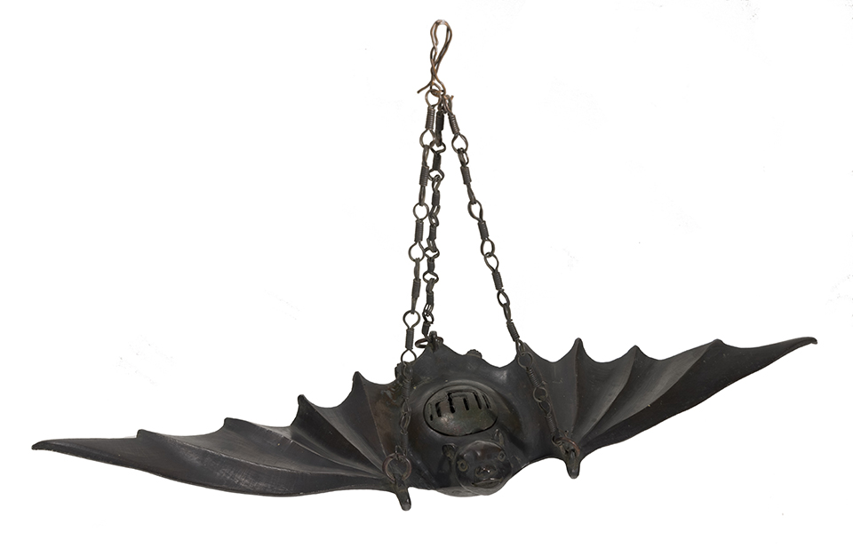 A bronze incense burner in the shape of a bat.