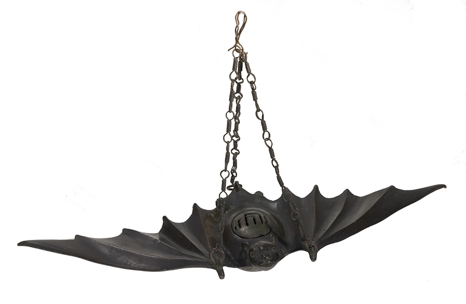 A bronze incense burner in the shape of a bat. A bronze incense burner in the shape of a bat.