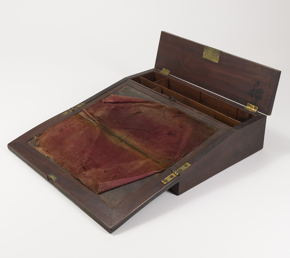 A wooden portable folding travel desk from the 1830s.