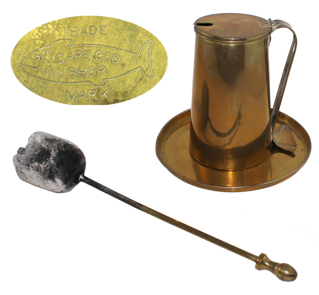 A fire starting wand and brass fuel pot made by the Cape Cod Shop.