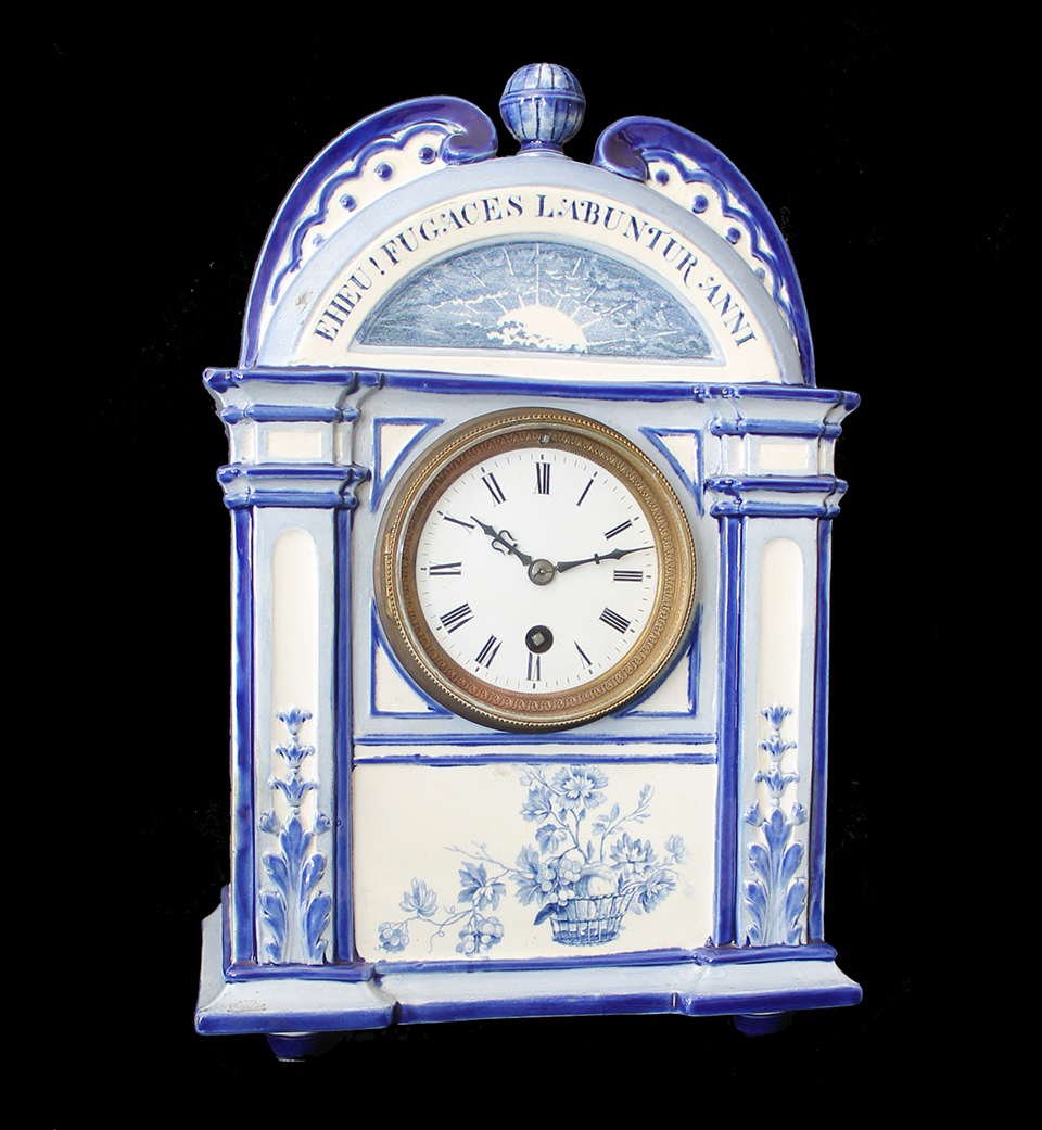 A blue and white porcelain Wedgwood mantel clock.