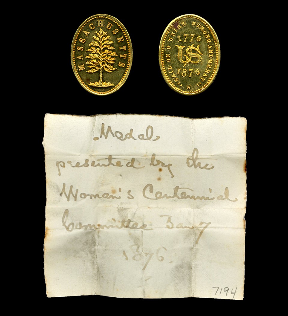 Front and back of an 1876 Massachusetts Women's Centennial Committee Medal, with accompanying note written by Henry W. Longfellow.