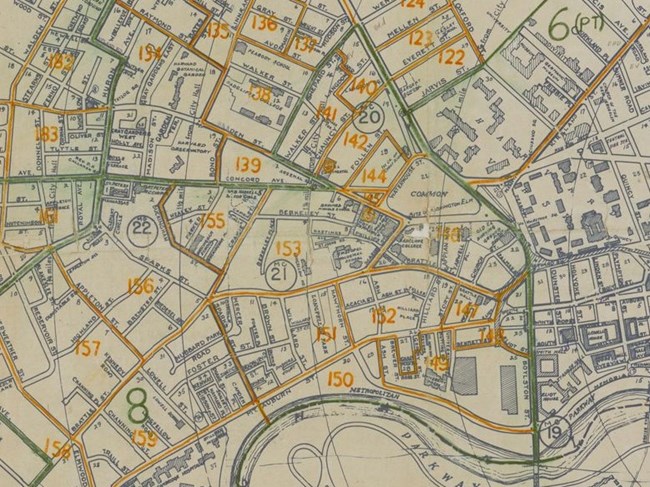 Street map of Cambridge with blocks outlined and numbered in green and orange print