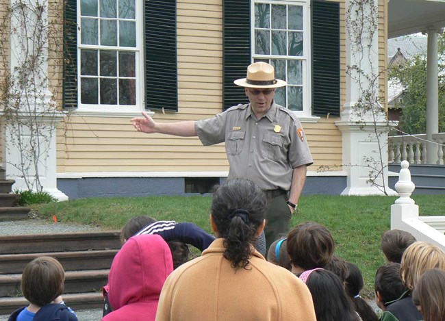 Ranger introduction for "Within the Walls" Ranger talking to group of children in front of Longfellow House
