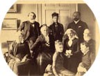historic sepia toned family portrait showing nine people in historic clothing