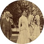 Black and white photograph of man and three women in formal clothes outside