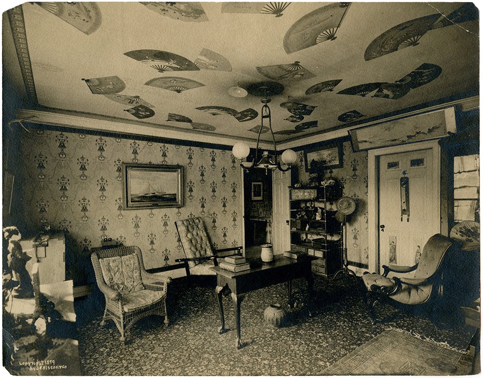 Black and white interior of room furnished with Japanese furniture and with the ceiling covered in fans