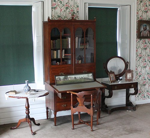 Secretary desk with framed panoramic picture and chair