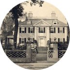 historic black and white photo showing a large white two story house