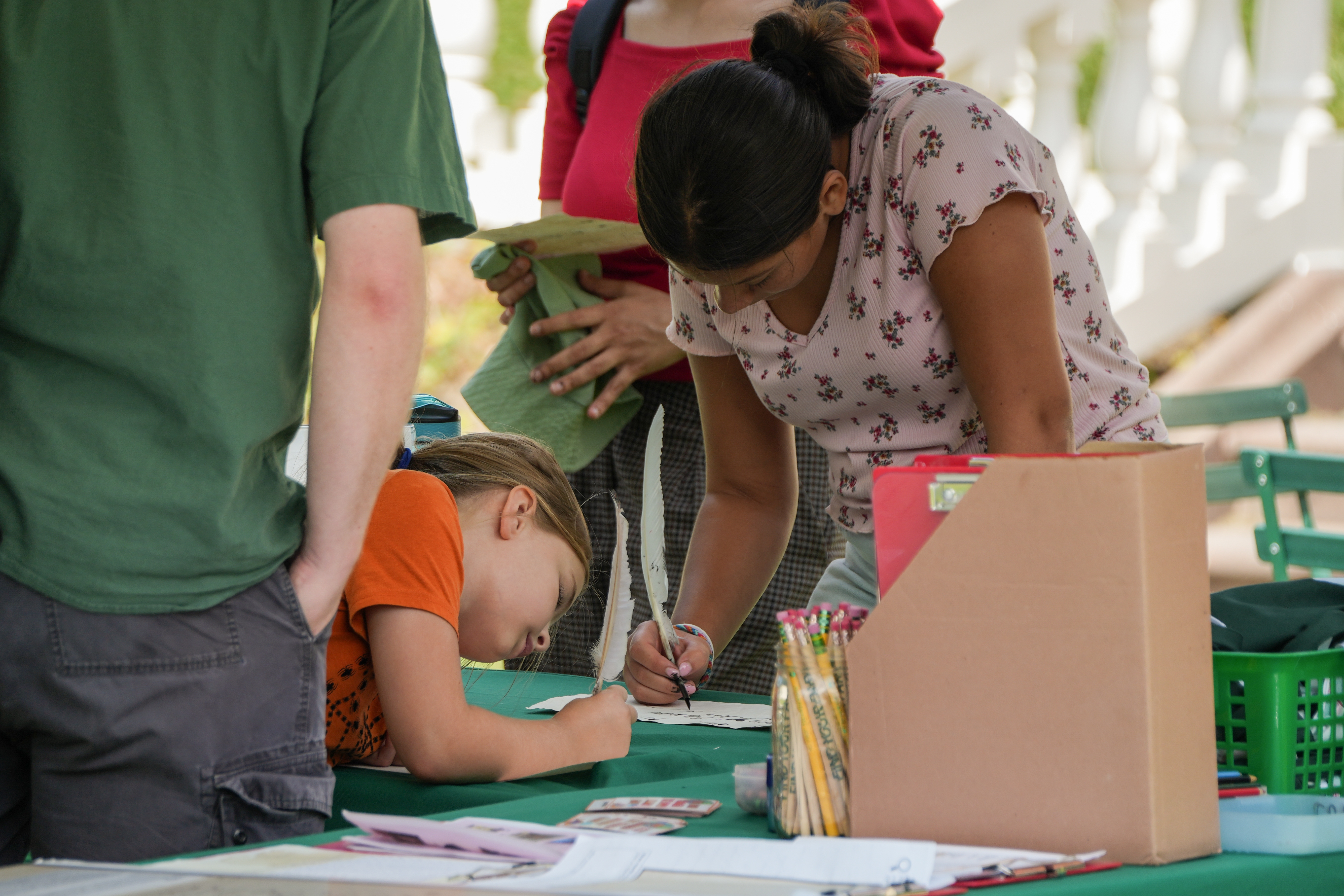 Visitors doing outdoor activities at a table
