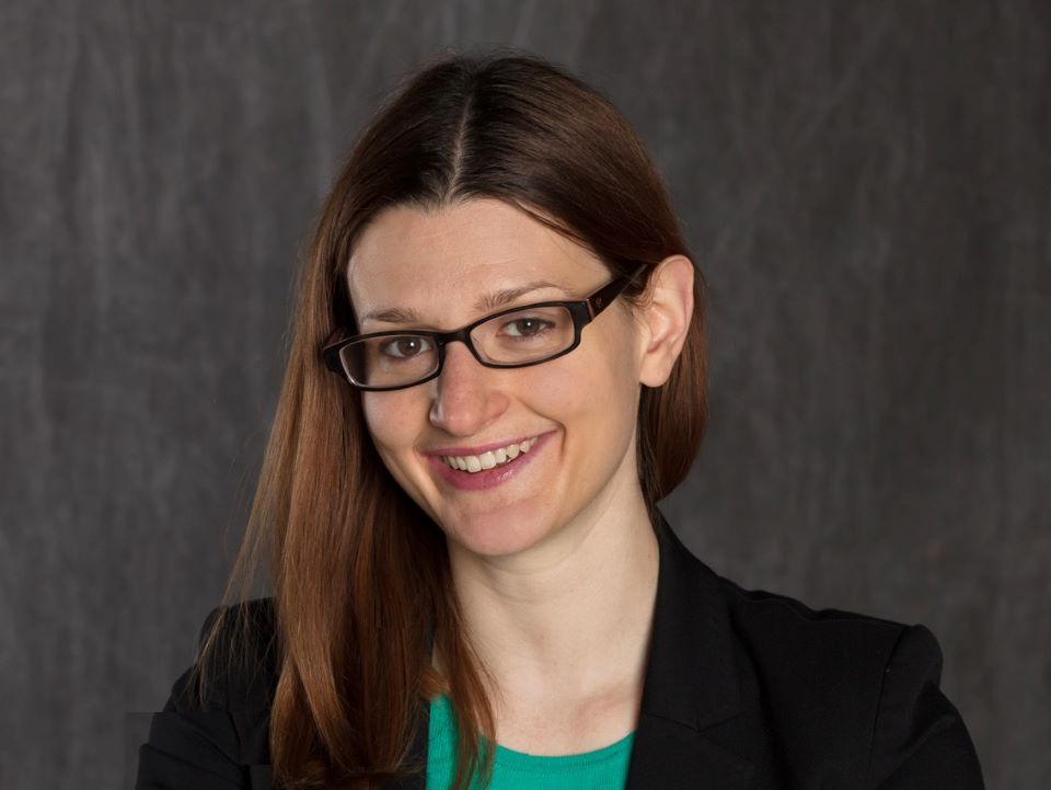 Portrait of smiling woman in blazer and glasses