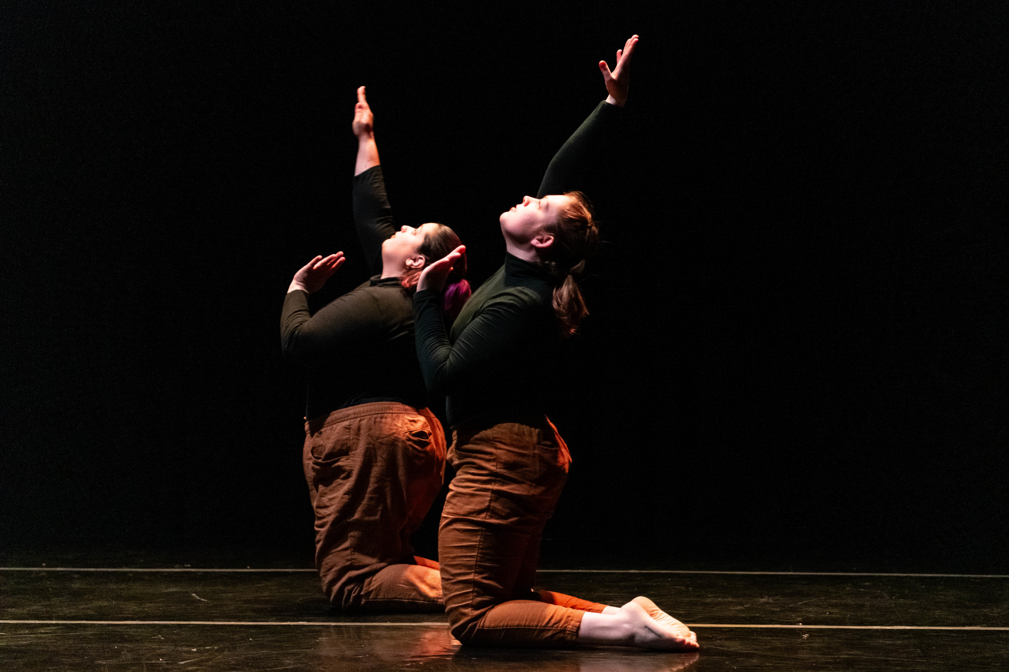Skeleton Dance Two dancers kneeling with arms raised