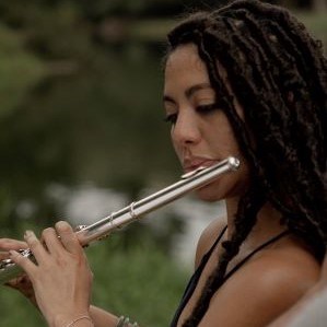 Jailene Michelle in profile playing a flute