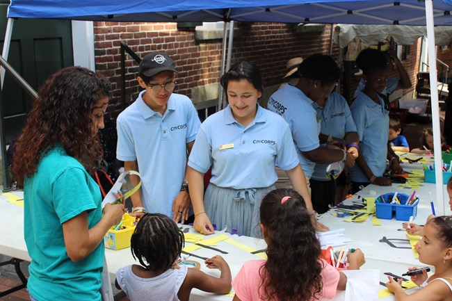 The Community Action Team helps kids with a craft