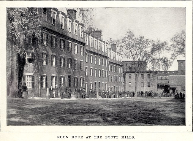 Workers filing out of a Boott Mills Boarding House at noon time