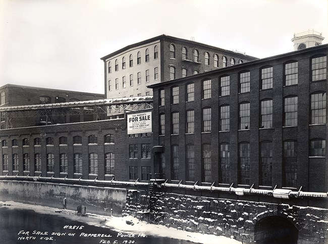 A 'for sale' sign is posted on a mill.