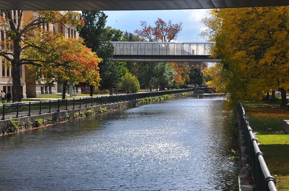 A park sits along a canal in downtown Lowell