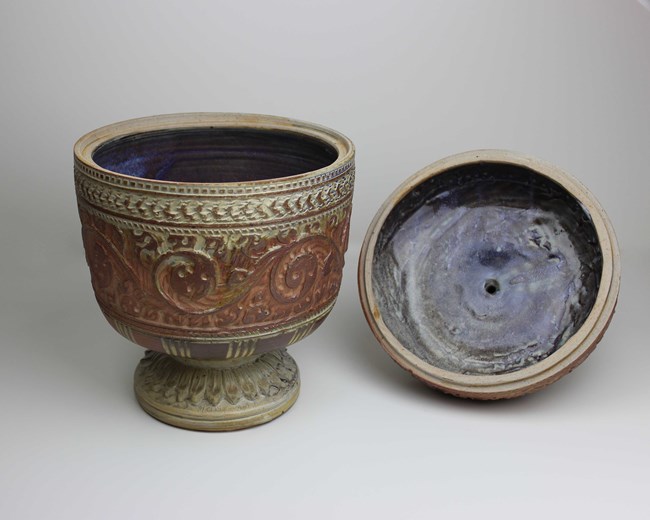 The jar has a rounded foot and low waist, with an ovoid body. The main motif on the jar are foliate swirls. Above this, there is a rope-like band, then a bead-like band. Then a pattern of boomerang-like shapes.