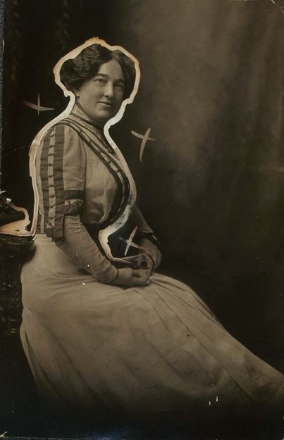 Margaret Foley sitting with her body facing away and her face towards the camera