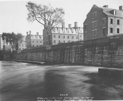 A row of brick boardinghouse along a canal