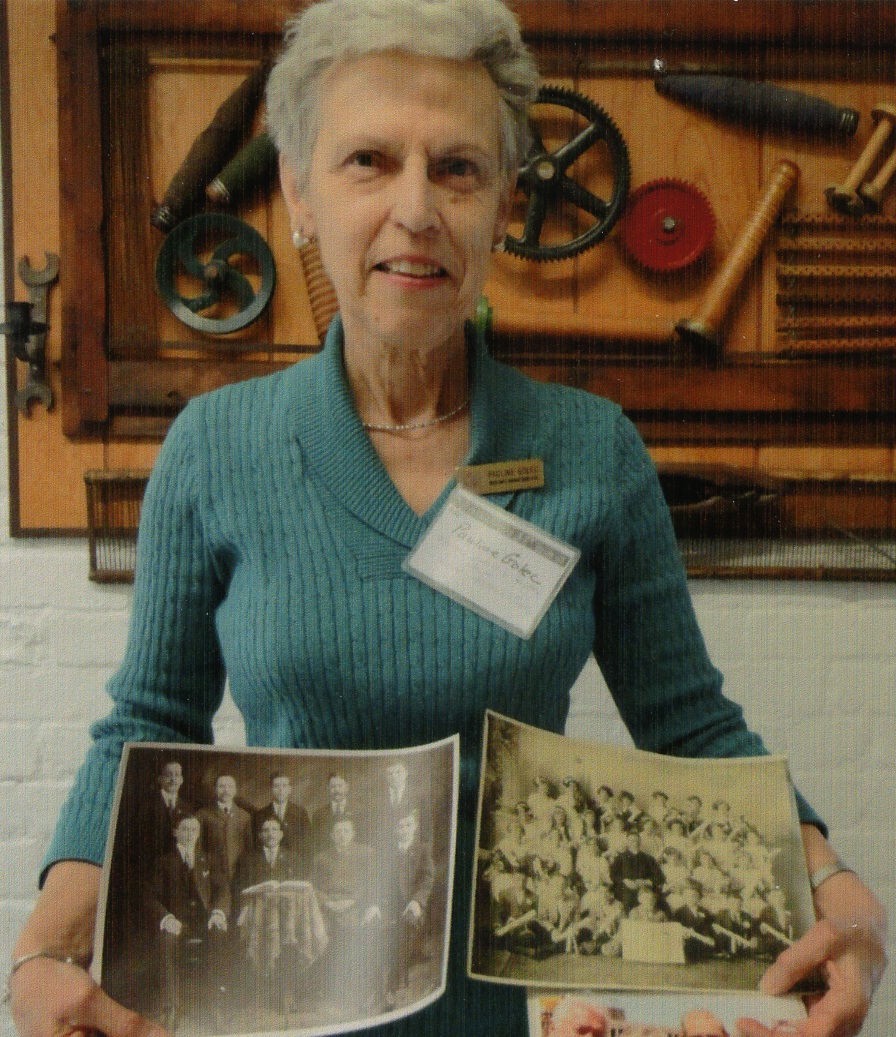 A woman poses with historic pictures