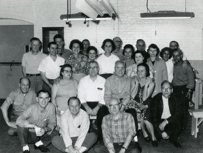 Black and white group photo of 24 men and women from the middle of the 20th century.